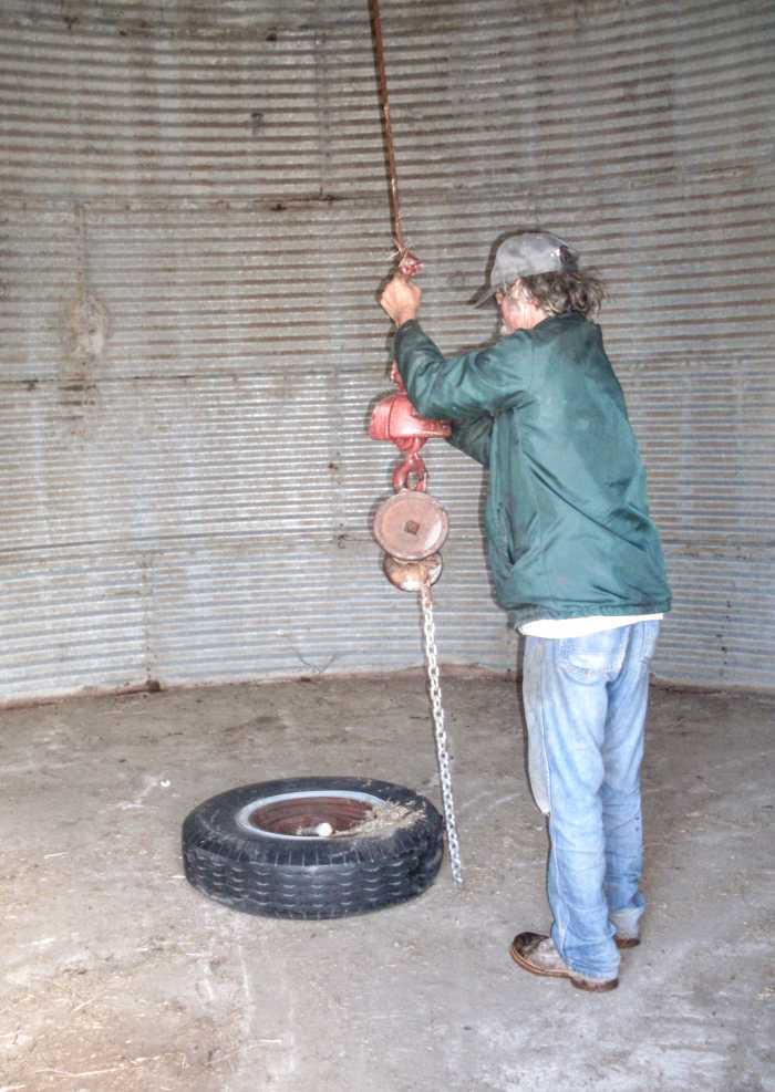 Attach lifting ring. There is such a thing as a specially-made lifting ring, but the one we commonly use is a large truck tire with a securely fastened log chain around it.