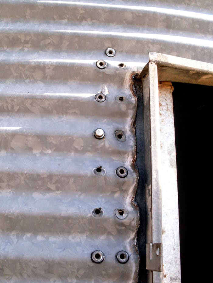 Leave one bolt at the top until last, so you can control until the last second how stable the doorframe is.