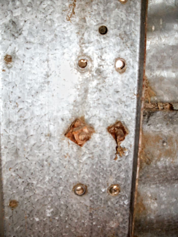 On many older bins, there are a variety of fasteners. Sometimes, they are rusted past loosening. You may need a torch for situations like this.