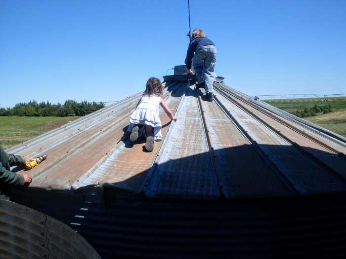 My kids, who have been on grain bin building sites nearly all their lives, can't resist a lowered roof.