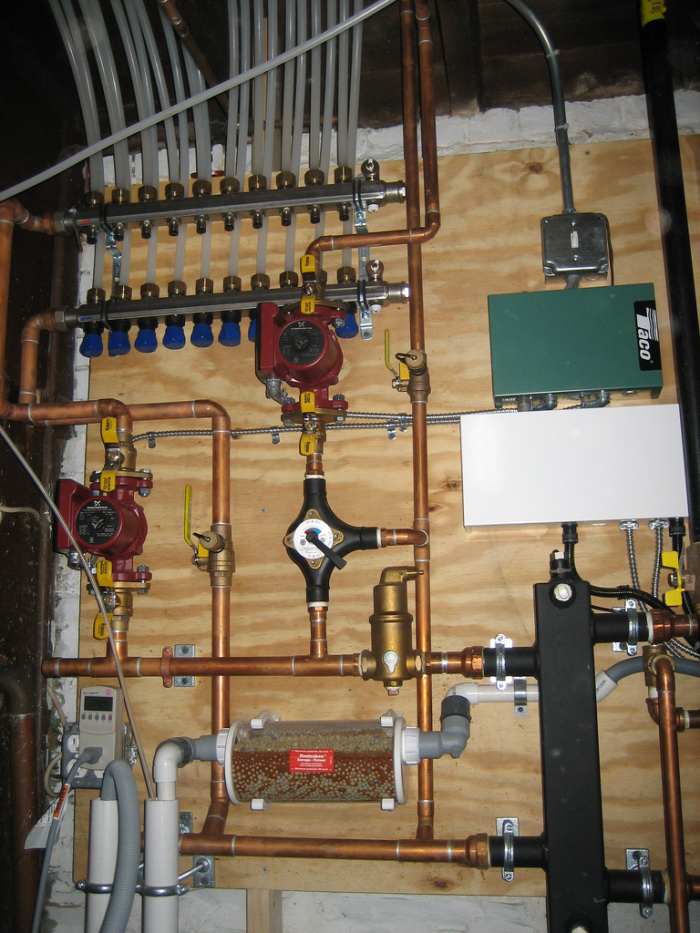 At top, a PEX distribution manifold co-exists right along with copper and other plumbing fixtures to service a boiler and radiant under floor heating system. CCL C