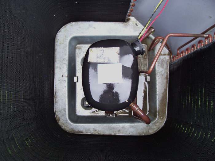 This is a top view of the compressor located in the center of the condensing unit. Other than cleaning your unit, you shouldn't really be in here but do note if you are, this may be very hot. Especially some of the copper lines attached to it.