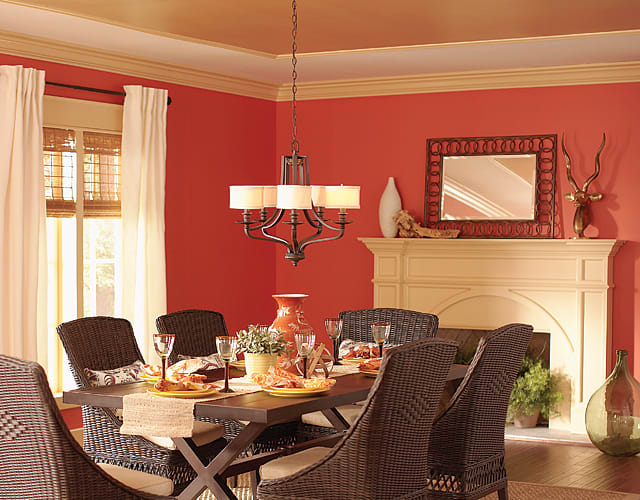 This ceiling features gold paint and brings the color down onto the wall with crown molding to visually increase the ceiling height.