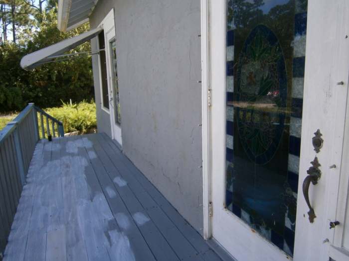 The porch is primed and ready for painting. You can see my dining room door that I faux-glass stained. Another project!