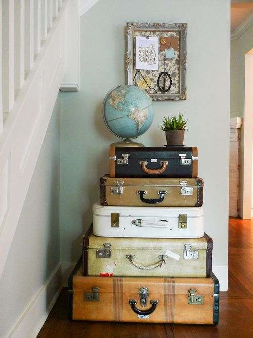Placing the globe and plant on top of the suitcases pulls the display together. No one will ever know that you use the suitcases as storage.