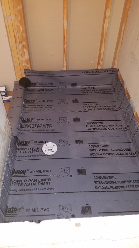 Notice how carefully the installer folded the pan liner corners. Tight corners like these make wall board installation easy.