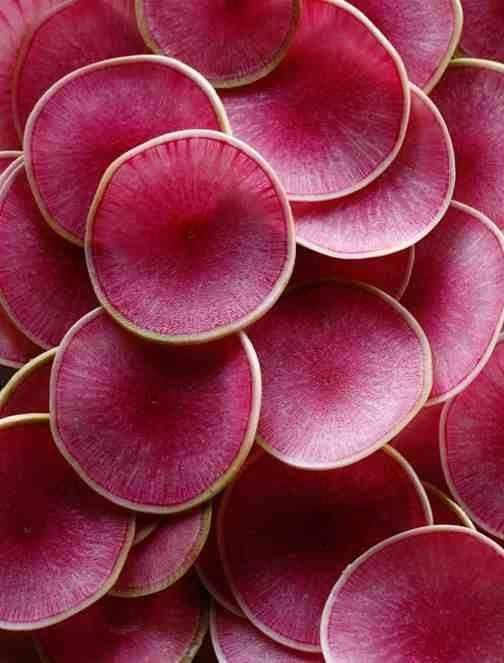Thinly sliced watermelon radishes. Not only would they be beautiful in a salad, their taste is wonderful as well.