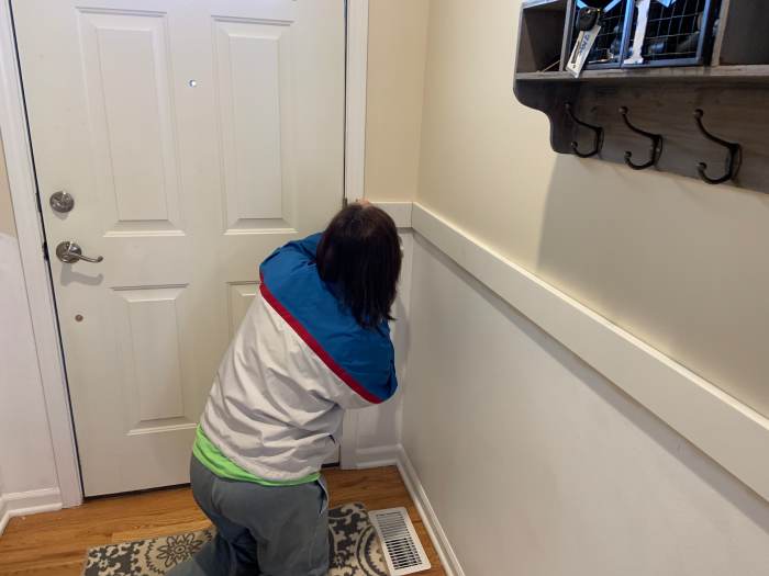 Installing the horizontal top board. We nailed the horizontal boards (1" x 4") to the wall studs to make sure they were secure.