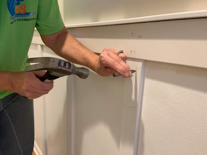 Using a countersink punch to the nails in the vertical slats. All the nails had to be countersunk into the wood so they could be painted over, thus making the final product smooth.