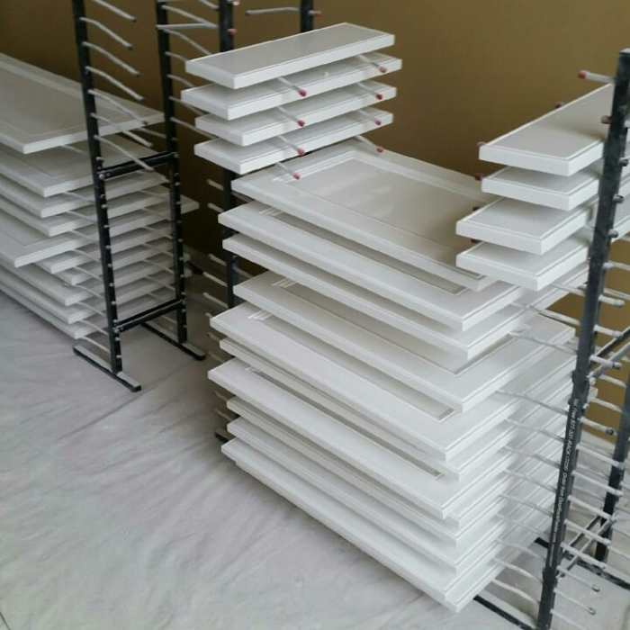 Freshly painted cabinet doors on my drying racks. The special design allows both sides to be painted at one time.