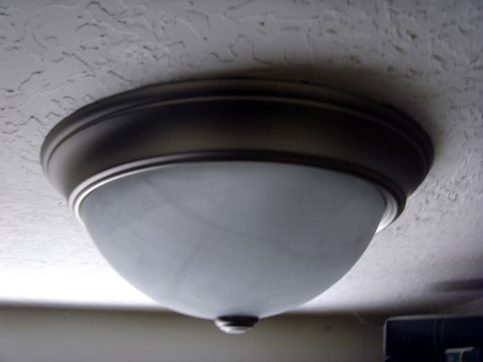 The old screws were left in place and re-used as the new fixture lined up perfectly. This is common and simplifies the process somewhat.