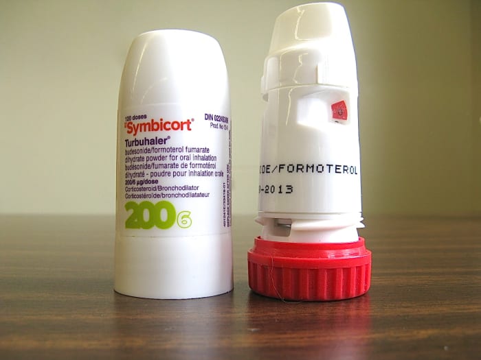 Symbicort is the name of an inhaler and a budesonide and formoterol powder. This photo shows the cap of the inhaler and the canister containing the powder.