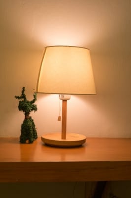 Ever noticed how hotels often have very low lighting? There's a reason for it. Bright light stimulates the cerebral cortex, or "thinking part" of your brain and can keep you awake. Low lighting has the opposite effect and helps you get to sleep