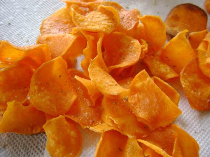 Sprinkle the hot chips with the seasoning mixture just after they come out of the hot oil. The seasonings will stick to the chip.