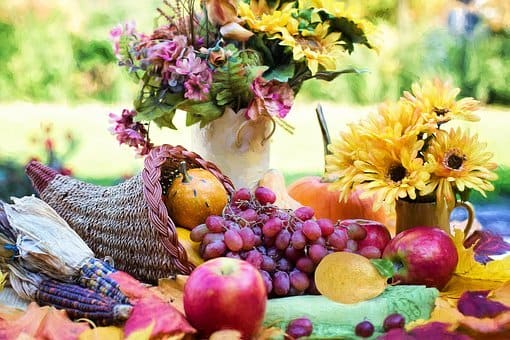 A cornucopia filled with real fruit rather than the artificial fruit often found in modern ones.
