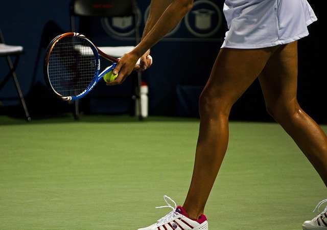 A women's tennis player lines up to serve. The serve is a crucial part of a player's tennis game and can often make the difference between winning and losing a match. It is important to be aware of the four main types of serve.