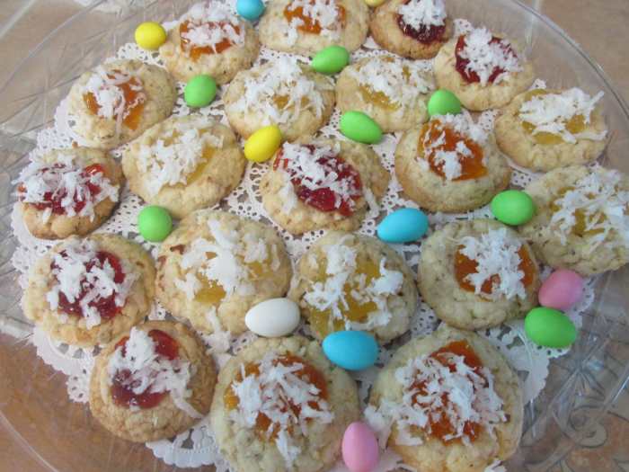 Coconut Thumbprint Cookies with three different toppings. Strawberry jelly, apricot preserves and pineapple preserves.