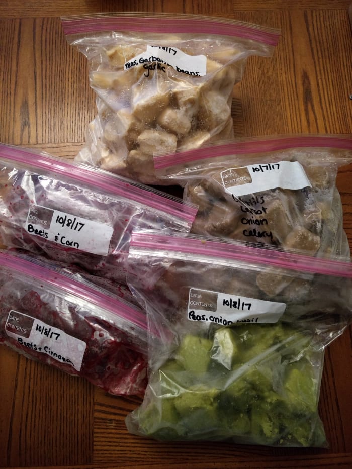 Freezing baby food in ice cube trays then storing in freezer bags is easy and less expensive than store-bought jars or pouches.