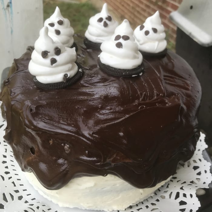 Luscious dark chocolate cake, simple buttercream, dark chocolate ganache, and homemade marshmallow ghosts make a perfect Halloween treat.