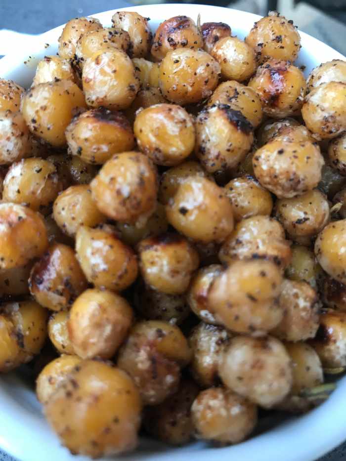 Crispy rosemary chickpeas? Such a great snack! Toasty, rosemary scented chickpeas are crispy, nutty, buttery and delicious. Eat them as they are, or throw them in a salad for a flavor and protein boost!