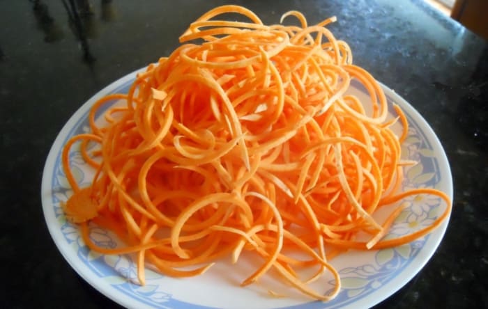 Swoodles - Sweet Potato Noodles - A peeled sweet potato is placed in the spiralizer. I find it easier to cut the potato in half so there is a flat side. The 1/8 inch (3 mm) blade was used.