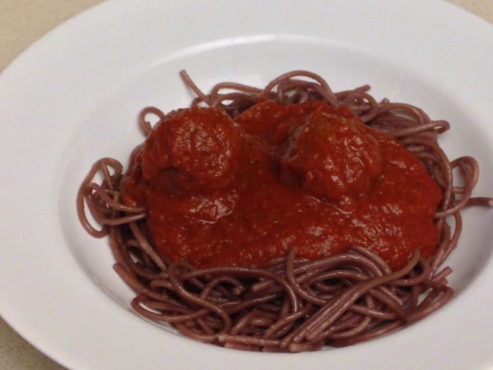 Drunken spaghetti noodles, boiled in red wine. Served with tomato sauce and meatballs.
