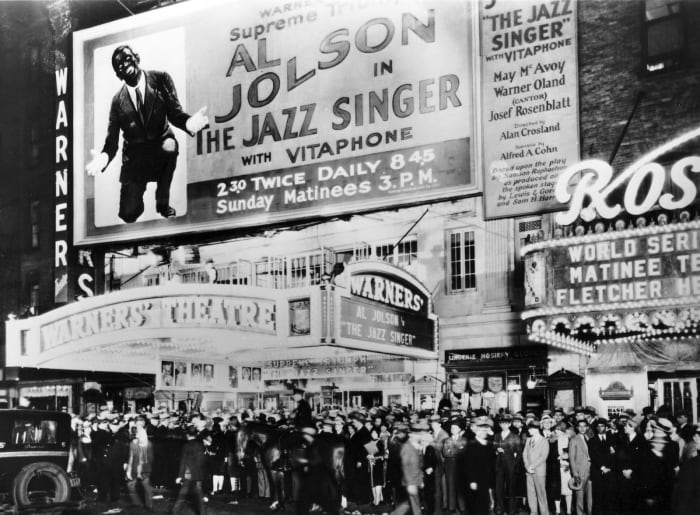 The crowd outside a theater showing Al Jolson in The Jazz Singer - the first Hollywood talking picture show.