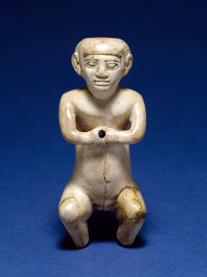 A figurine of a male dwarf made out of hippopotamus ivory. (late Old Kingdom approx. 2200)