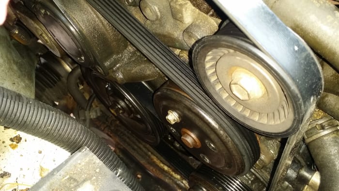 The water pump is located in bottom, center of image. It is the pulley with only one of its four small bolts attached.