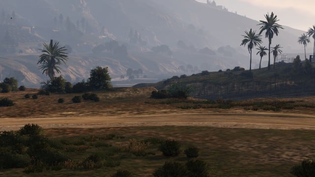 You can use this landmass to enter the base easily, aim for between these two bushes to clear the fence. The next-gen version has more foliage making the "land ramp" in the first screenshot harder to spot (as seen in the video walkthrough).