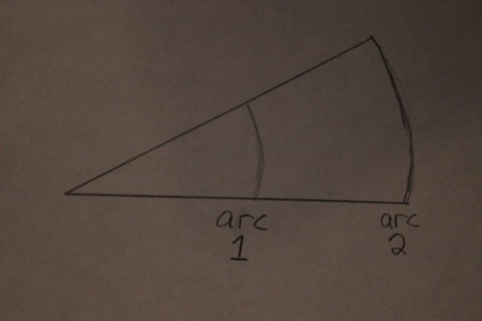 Both arcs have the same angle, but arc 2 has more length by which to reference changes in angle. Use arc 2.