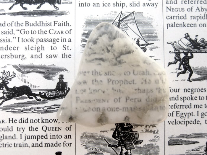 No, ulexite is not transparent, but milky white all the way through. The image you see is projected on top of the rock!