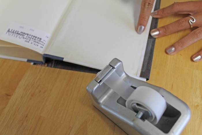 Put a little transparent tape to hold the cover in place so that you can put the washi or masking tape over it.
