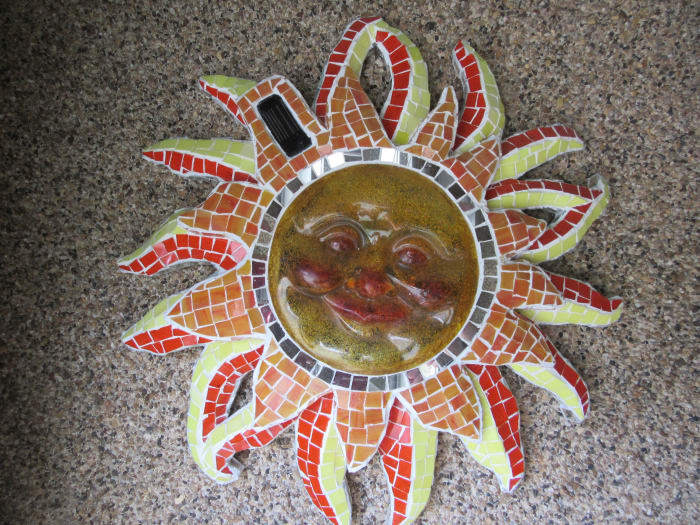 Using a glass mosaic technique on a common plastic piece adds richness to this solar light fixture.