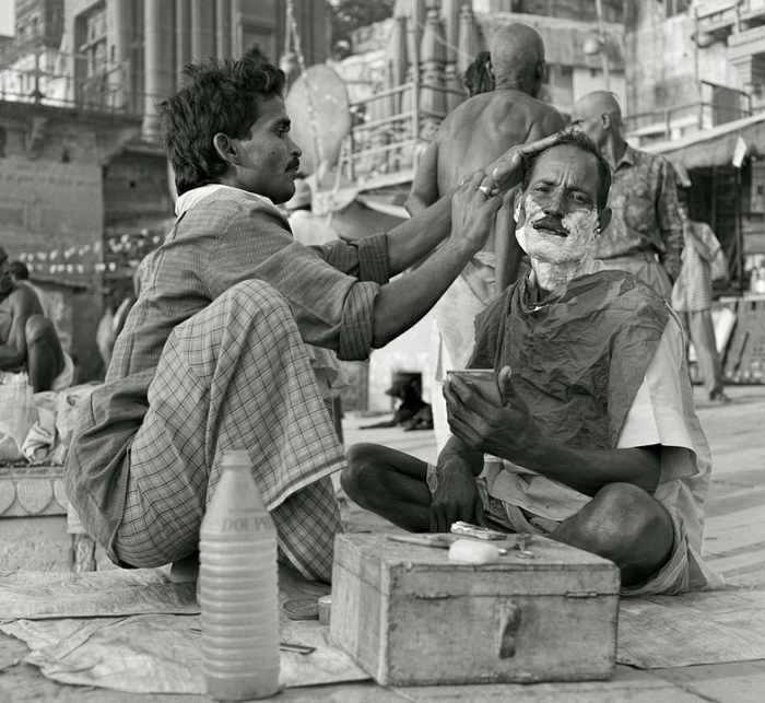 This is a man shaving another man. Teens in my day just shaved by ourselves--part of our growing up ritual in America.