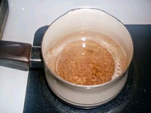 The flax mucilage is glossy, bubbly, thickened and cohesive, with the seeds suspended in it, and has small white streaks through it.