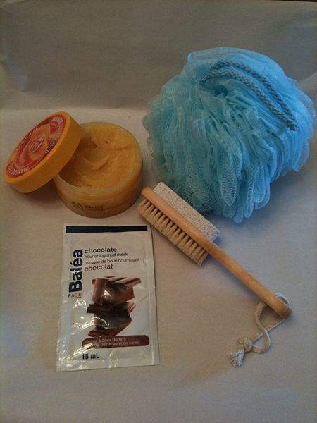 The items in this picture are used to exfoliate the skin. The tool on the lower right is a pumice stone used to dislodge dead skin on the surface. The pumice stone is combined with a brush to clear away the dislodged skin.