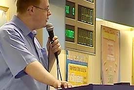 This is a bingo caller in a professional hall. You don't need to be this good, but you can learn a lot from them should you ever need to call a game of bingo.