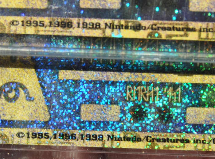 The one on the bottom is the famous Japanese Ancient Mew I Error card. The error was the misspelling of Nintendo spelled as Nintedo. The corrected version is much more rare.