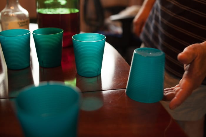 When finished with a beer players place cups upside down on the table and try to flick the cups by their overhanging rims to turn the cups right side up.