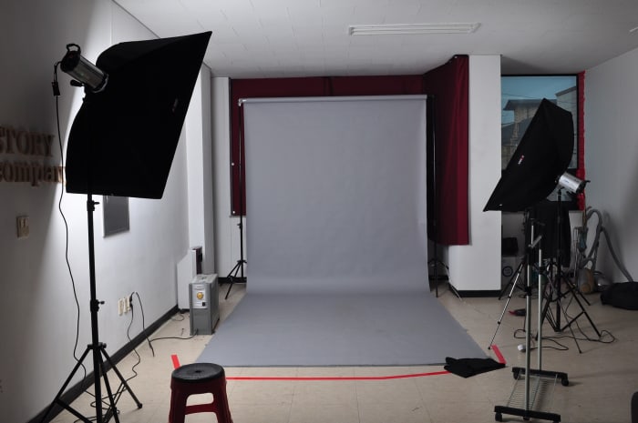 Use one wall for the dual function of practicing in front of a stage and for photographing or video taping promotional material.