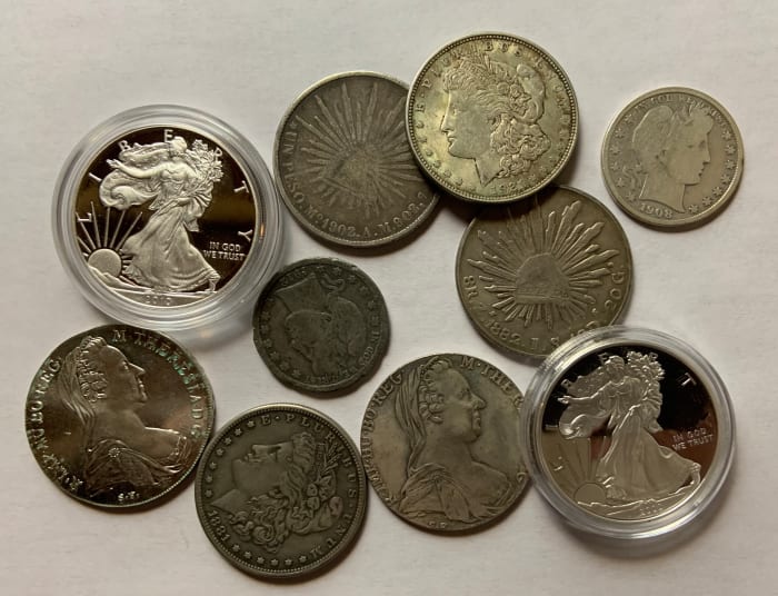 Half the coins in this picture are real and half are counterfeit—can you tell the difference? If not, read on.