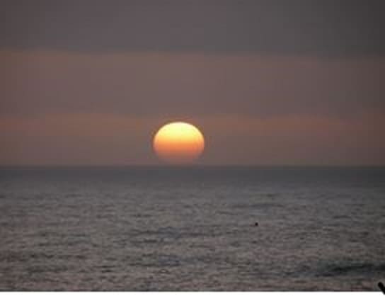 In this undated photo, the sun sets on the Pacific Ocean off California's Big Sur region.