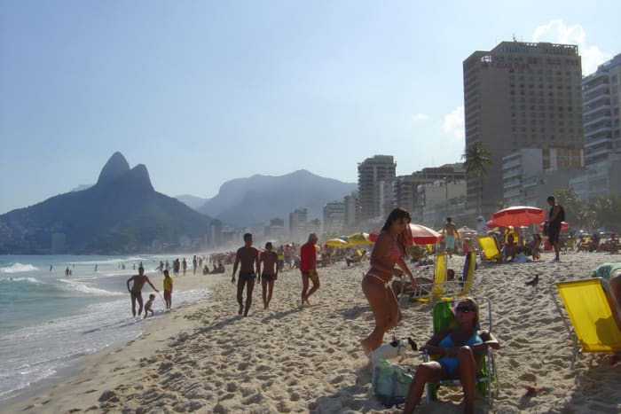 Ipanema, one of the most popular beaches in Rio, faces the Atlantic. In the background are the Two Brothers mountains and many high-rise buildings.
