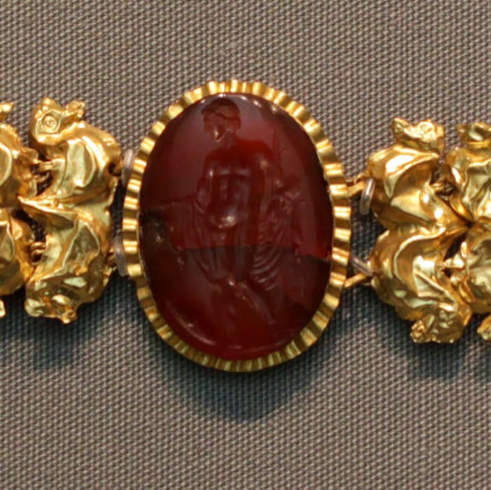 An image of engraved carnelian. This gemstone was highly valued in ancient times, often made as engraved jewelry used as protection.