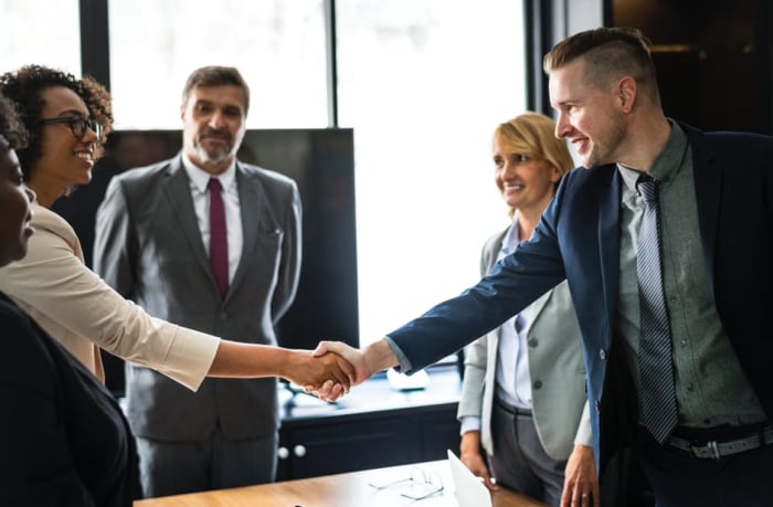 Office Quiz: Is this the proper handshake for women and men? Answer: Yes. The man and woman should NOT be any closer than what you see here.
