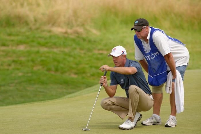 Australia's Richard Green and his caddie read the 9th-hole green during round 3 of the French Golf Open at the Golf National in Saint Quentin en Yvelines, Saturday July 6th 2013.