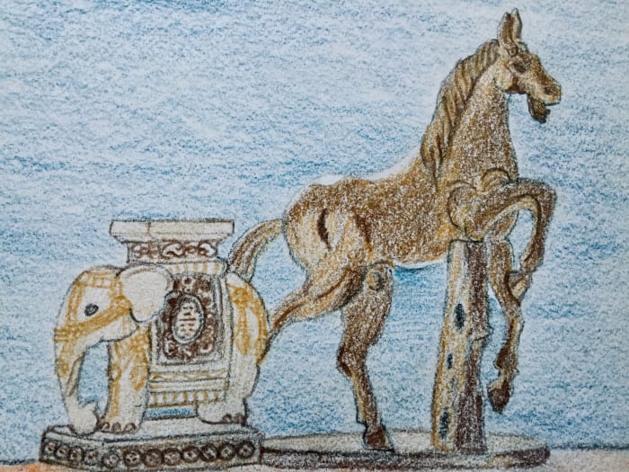 A ceramic elephant plant stand and wooden horse that I sketched using colored pencils.