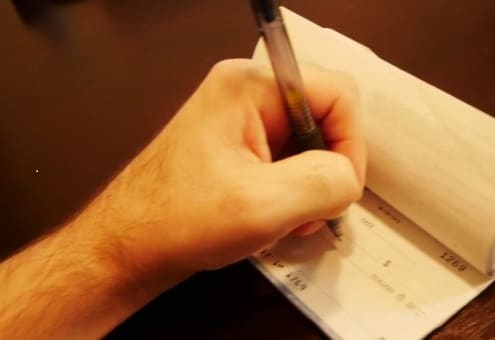 Here a check is being written. Interesting, most businesses are moving towards automating the process of receiving a check by having a computer fill out the check for the customer.