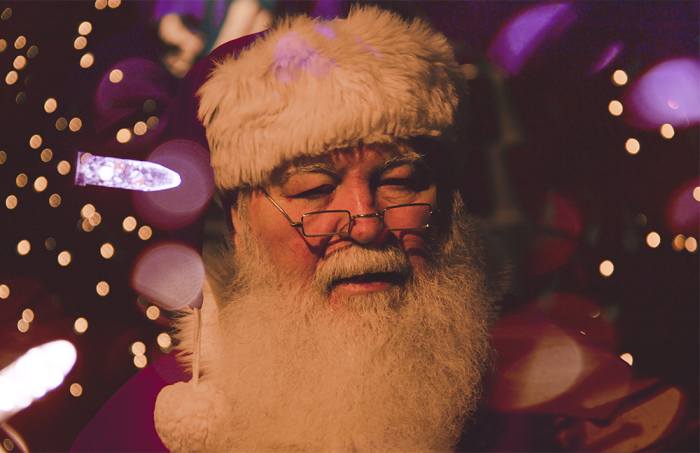 Our modern version of Santa is usually depicted with a long, white beard, glasses, and a pointy hat.